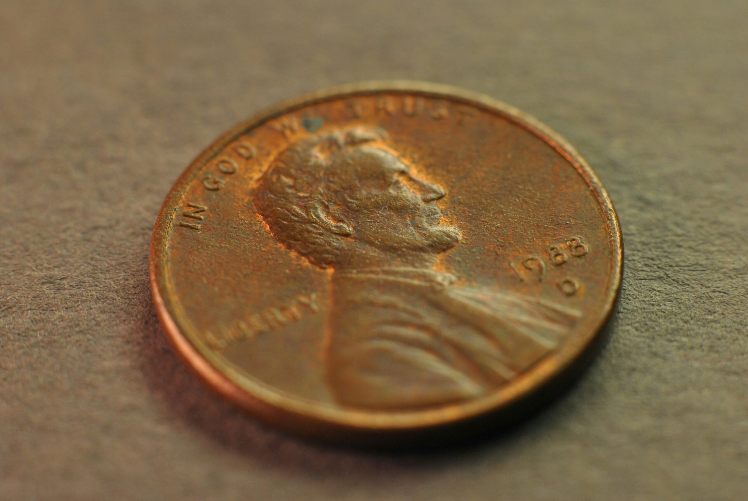 A single penny in soft light symbolizing a quiet sign